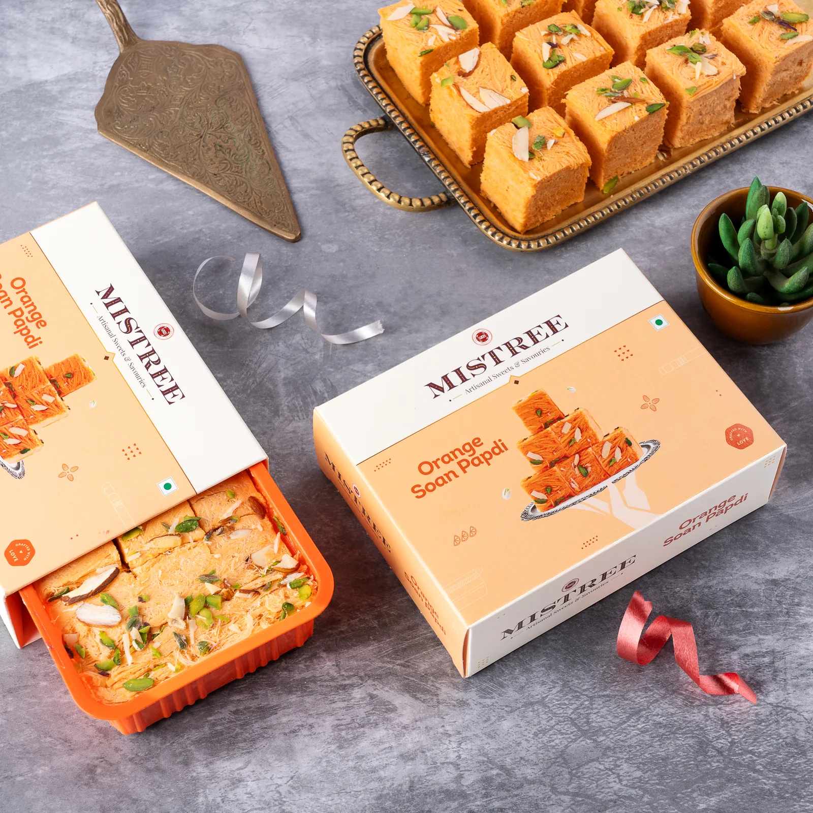 Orange soan papdi, boxed and opened