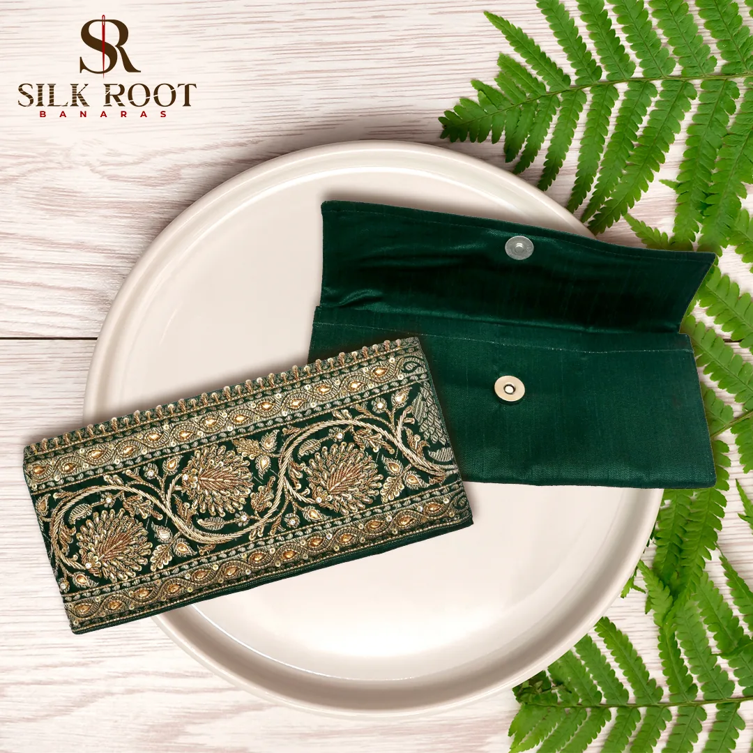 Green brocade envelopes on a white plate
